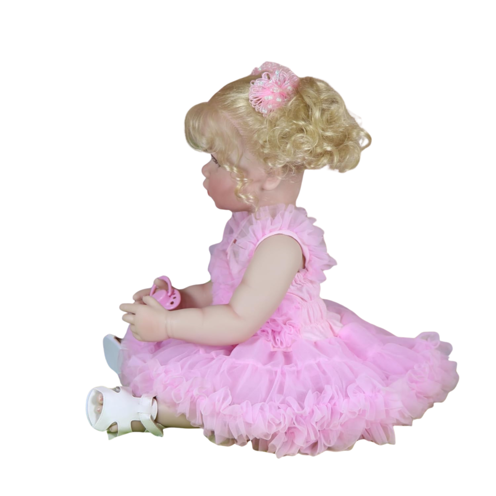 Side profile of Aubrey Rose reborn toddler showing realistic poseable limbs and blonde hair curls