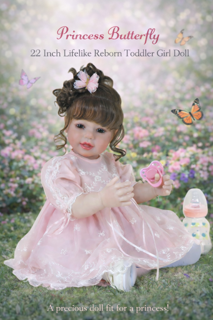 Enchanting Princess Butterfly 22-inch realistic reborn toddler girl doll with full vinyl body and rooted brown hair sitting in a garden wearing a pink lace dress