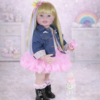 Enchanting Rainbow Dreams 22-inch reborn toddler standing with blonde hair and rainbow highlights wearing a denim jacket pink tutu dress black boots and pink magnetic pacifier