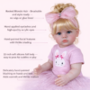 Ellie Mae toddler doll showing rooted blonde hair, hand-painted facial features, and soft vinyl body