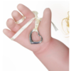 Close-up reborn doll hand holding heart pendant necklace accessory for Happy Birthday Girl doll