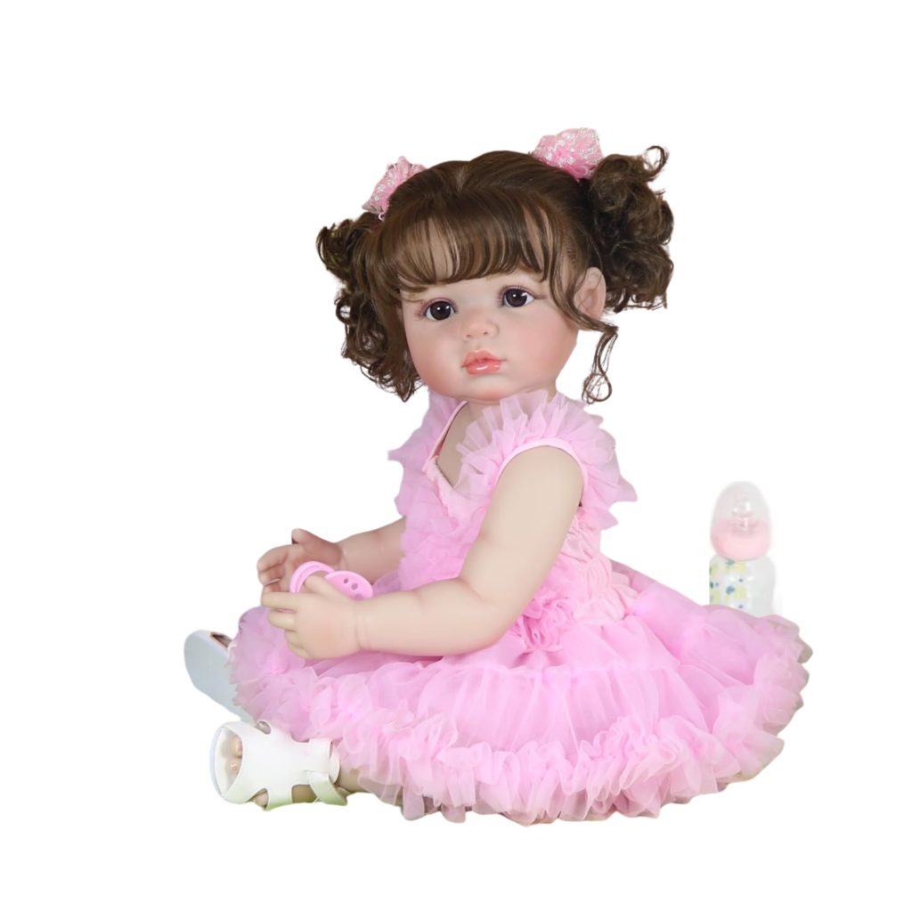 Madison in Pink reborn toddler doll sitting on chair wearing pink ruffle dress with curly pigtails and white sandals
