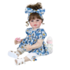 Sweet Dreams Daisy 22 inch reborn toddler doll sitting pose in blue floral outfit with white sandals and accessories