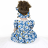 Back view Sweet Dreams Daisy reborn doll showing brown curly hair and blue daisy dress with bow headband
