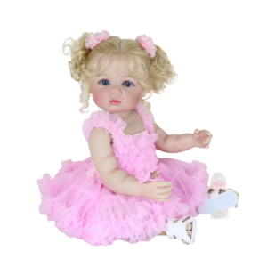 Aubrey Rose 22 inch reborn toddler doll sitting in pink ruffle dress with curly blonde pigtails and blue eyes