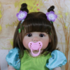 realistic reborn baby doll blossom belle close up face with wavy hair with pacifier