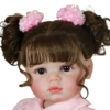 Close-up Clara Bloom reborn baby doll with lifelike hand-painted face brown eyes and soft expression
