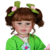 Froggy Girl reborn toddler doll close-up with green eyes, brown hair, and curly pigtails