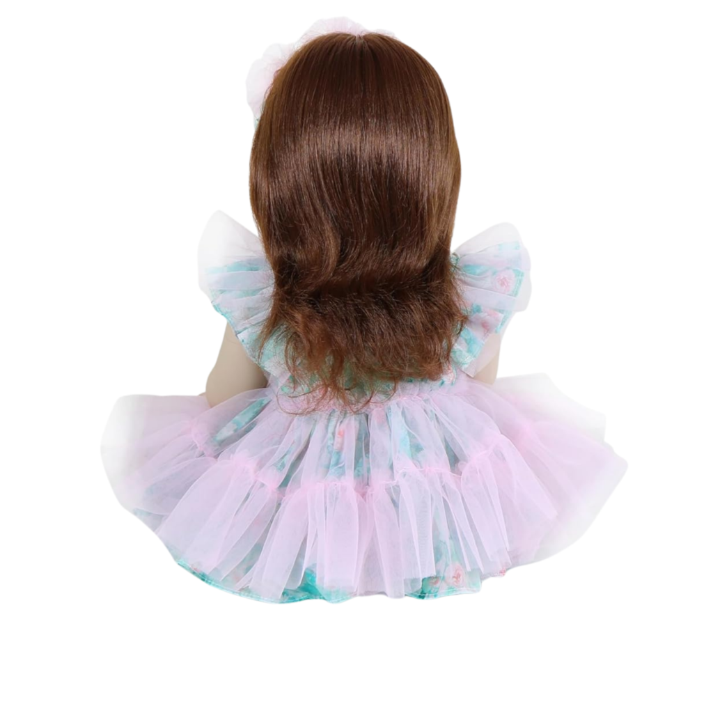 reborn toddler doll back view showing long brown hair and dress