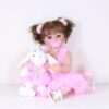reborn toddler doll pink dress set with bunny and bottle front view