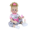 Realistic Luna Mae reborn toddler doll with blonde hair wearing grey romper outfit with baby bottle accessory