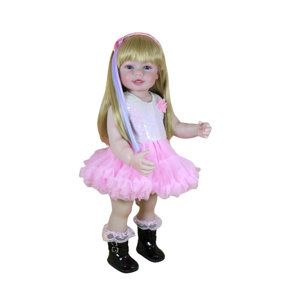Rainbow Dreams reborn toddler doll wearing pink tutu dress with rainbow hair accessory standing full body view