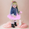 Rainbow Dreams reborn doll in pink tutu dress and denim jacket with rainbow hair ribbon styled studio setup