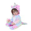 Reborn baby doll in rainbow unicorn outfit holding baby bottle and pacifier, side view