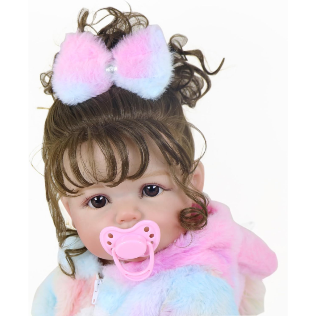 Realistic baby doll with pacifier and curly brown hair wearing soft rainbow outfit