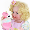 close up Sunny Flamingo Girl reborn doll face with blue eyes blonde curls holding flamingo plush toy