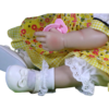 Bella Sunshine reborn doll detail of hand pacifier yellow floral dress fabric and white shoes
