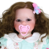 Close-up Sweet Curly Sunshine reborn doll with pink magnetic pacifier and lifelike facial features