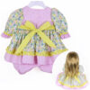 22 inch doll wearing pastel floral ruffle dress outfit with bloomers and matching flower hair accessory